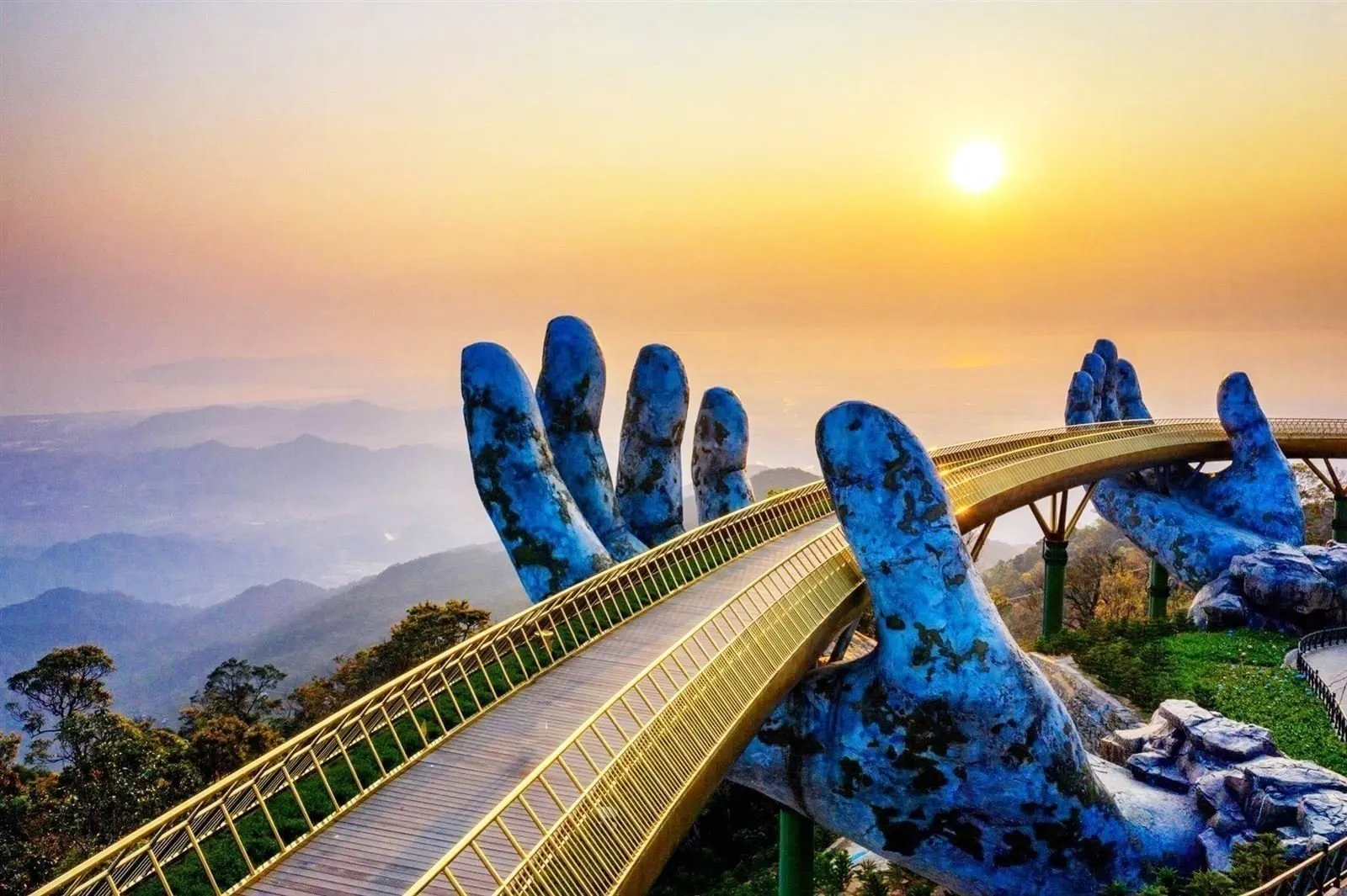 Golden Bridge Ba Na Hills held by giant stone hands panoramic mountain view Bali
