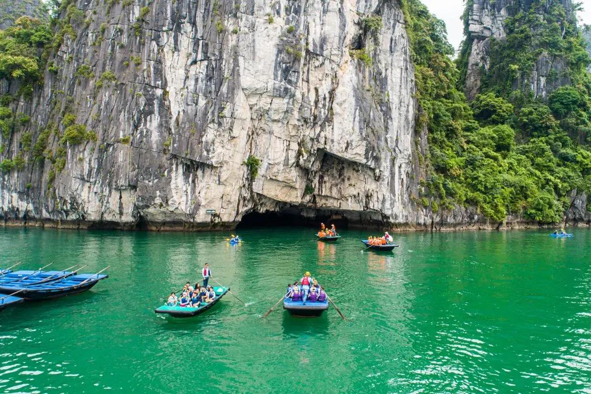 Kayaking through hidden lagoon limestone cave Lan Ha Bay Cat Ba Bali