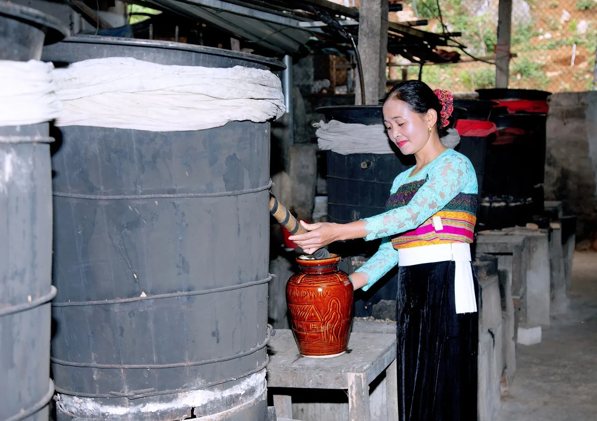 Thai traditional rice wine communal jar bamboo straws mai chau Bali