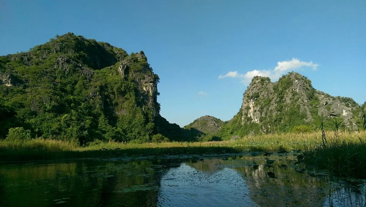 Van Long wetland nature reserve bamboo boat ride karsts Bali