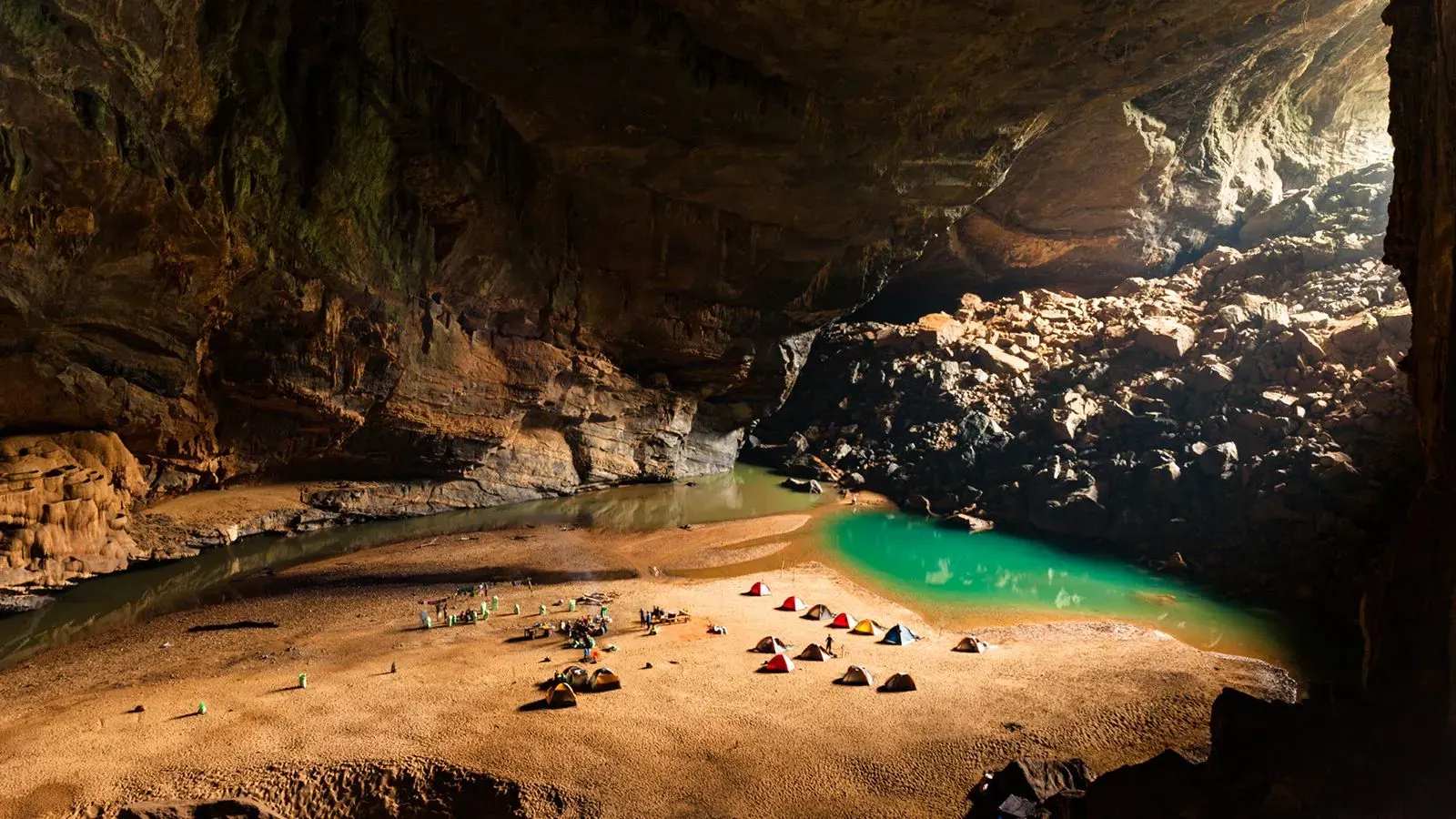Son Doong Cave interior vast chamber with internal jungle sunbeam Phong Nha Bali