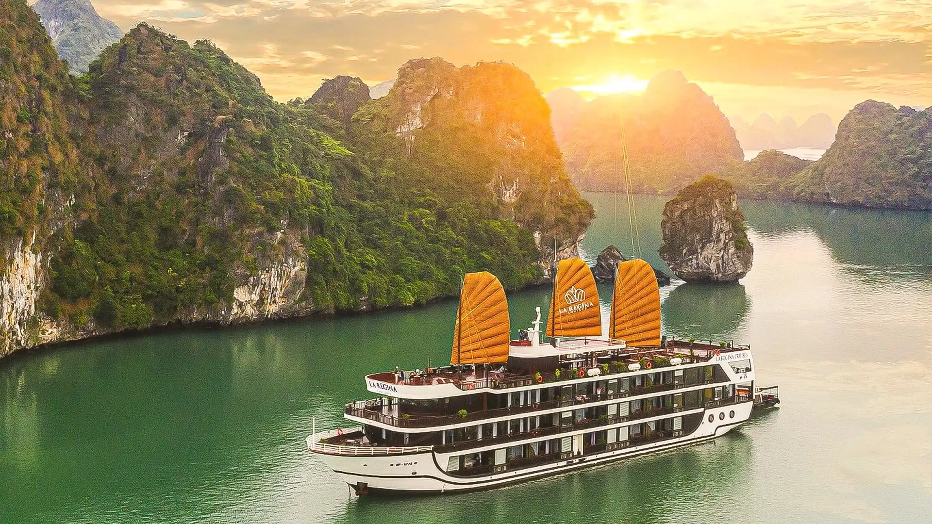 Ha Long Bay limestone karsts and cruise boat in emerald waters Bali